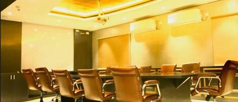 A conference room with a long table and multiple chairs.