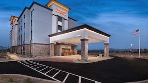 A modern hotel with a prominent sign, a covered entrance, and a parking lot. - Hampton Inn & Suites Tucson Tech Park (Tucson)