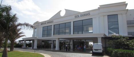 A modern building with the name "MELIA DUNAS" and "SOL DUNAS" on the facade.