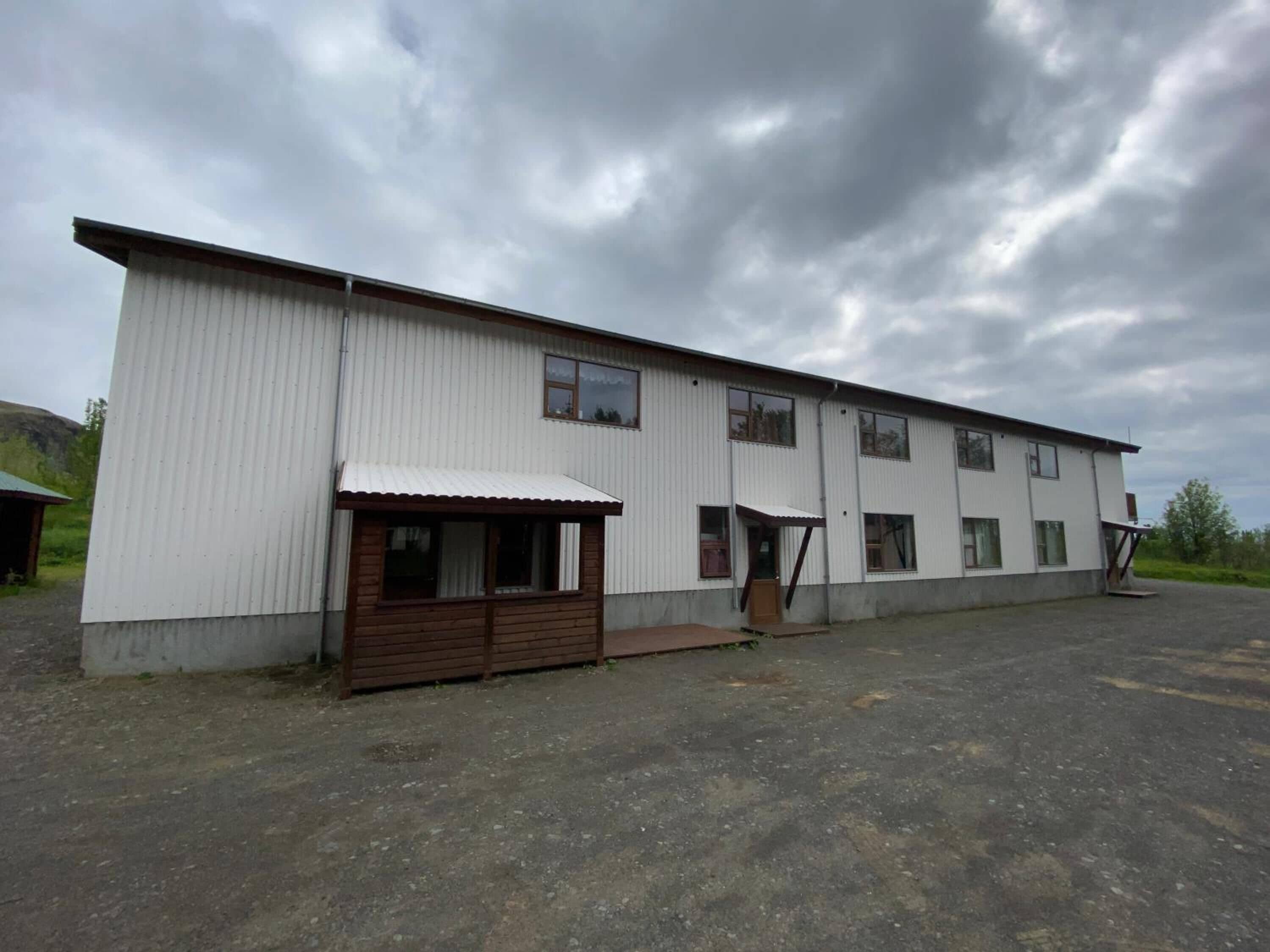 A large, single-story industrial building with a flat roof and a covered loading dock.