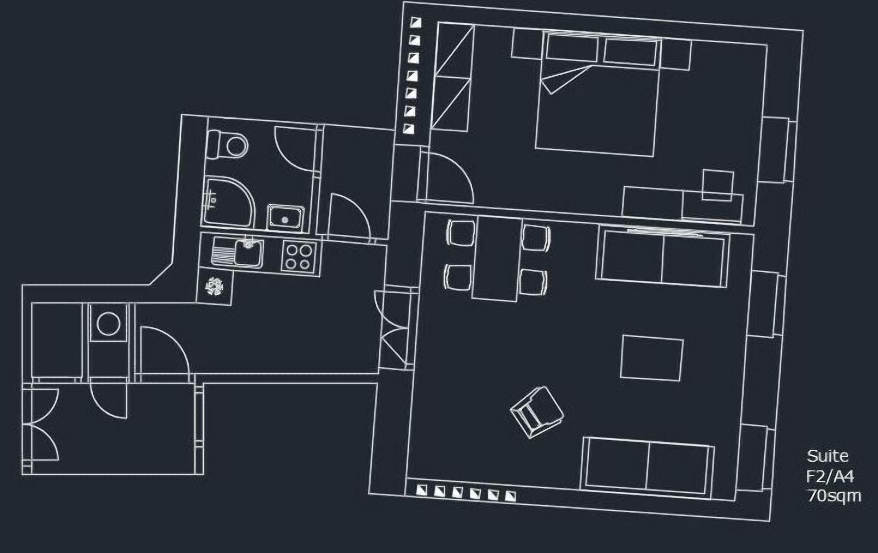A floor plan of a hotel suite with a kitchenette, a bathroom, and a living area.