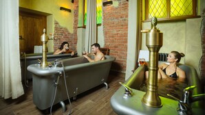 A room with three vintage-style bathtubs, each with a brass fixture. - Letna Garden Suites (Prague)