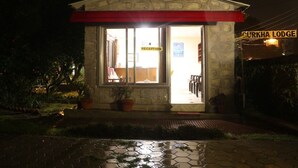 A stone building with a reception area, potted plants, and a sign reading "Turkha Lodge". - Gurkha Lodge (Pokhara)