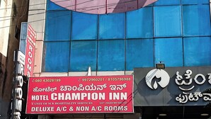 A hotel sign with "HOTEL CHAMPION INN" and "DELUXE A/C & NON A/C ROOMS" indicating room types. - Hotel Champion Inn near Yeswantpur Junction Railway Station (Bengaluru)