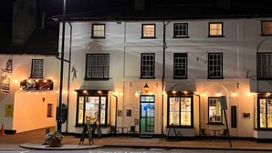 A two-story building with multiple windows and a ground-floor entrance. - The Black Lion Royal Hotel (Lampeter)