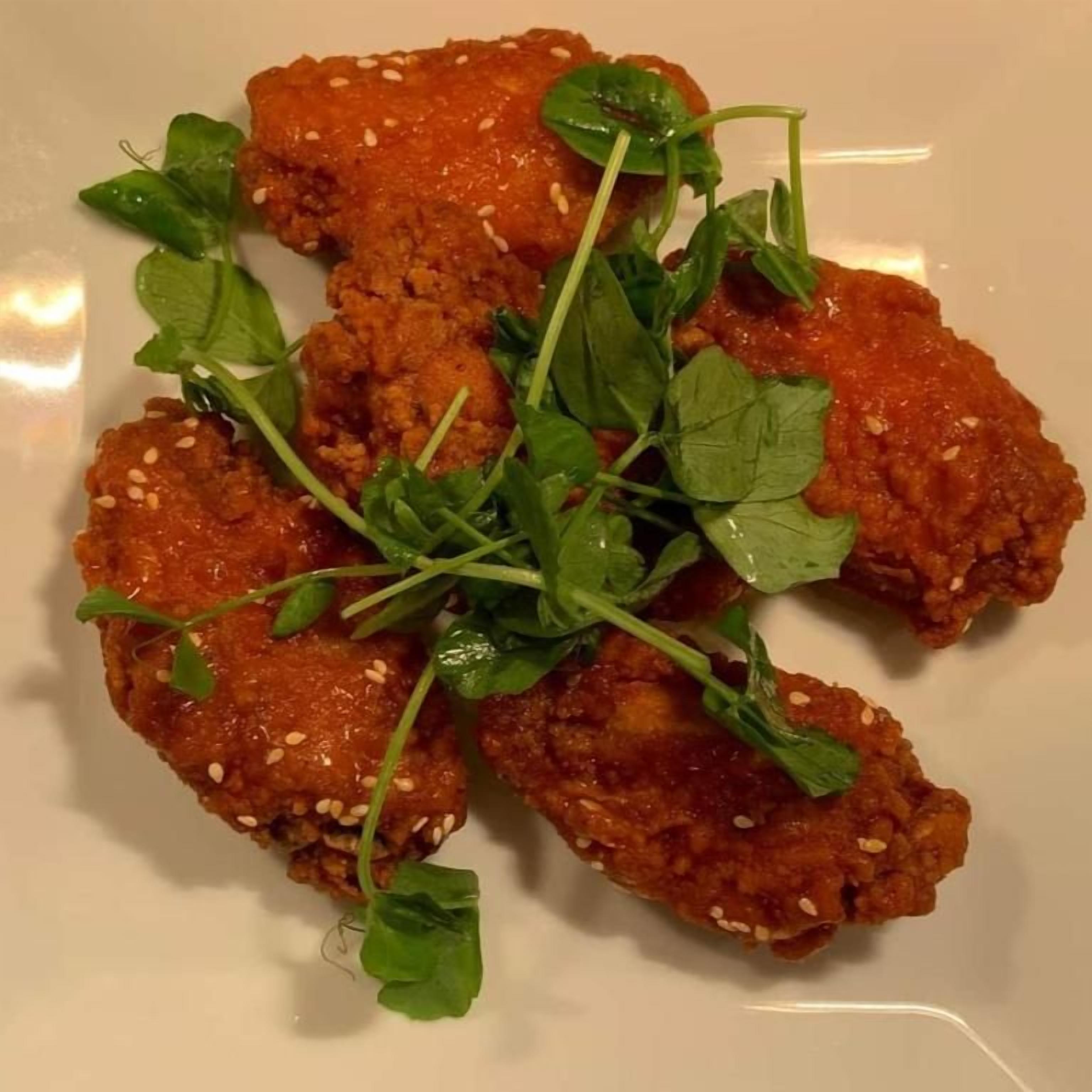 A plate of food with sesame seeds and green garnish.