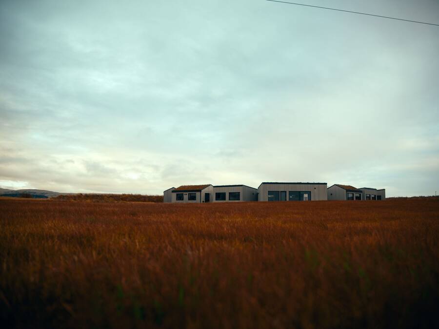 A modern building with a flat roof, large windows, and a simple, rectangular structure.