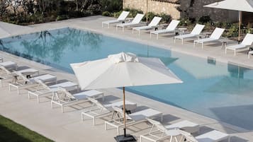 Seasonal outdoor pool, open 10:00 AM to 7:00 PM, pool umbrellas