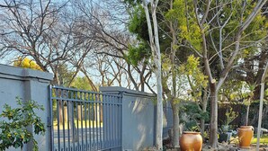 A hexagonal tiled patio with a water feature and potted plants. - 51 on Church Guesthouse (Matjhabeng)