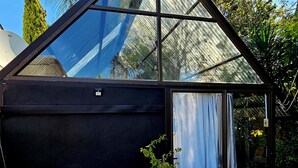A modern greenhouse structure with a triangular roof and large glass panels. - 51 on Church Guesthouse (Matjhabeng)