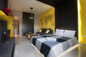 A modern bedroom with a large bed, a world map on the wall, and a desk with a television. - Patisia, Modern Studio with Unique View (Athens)