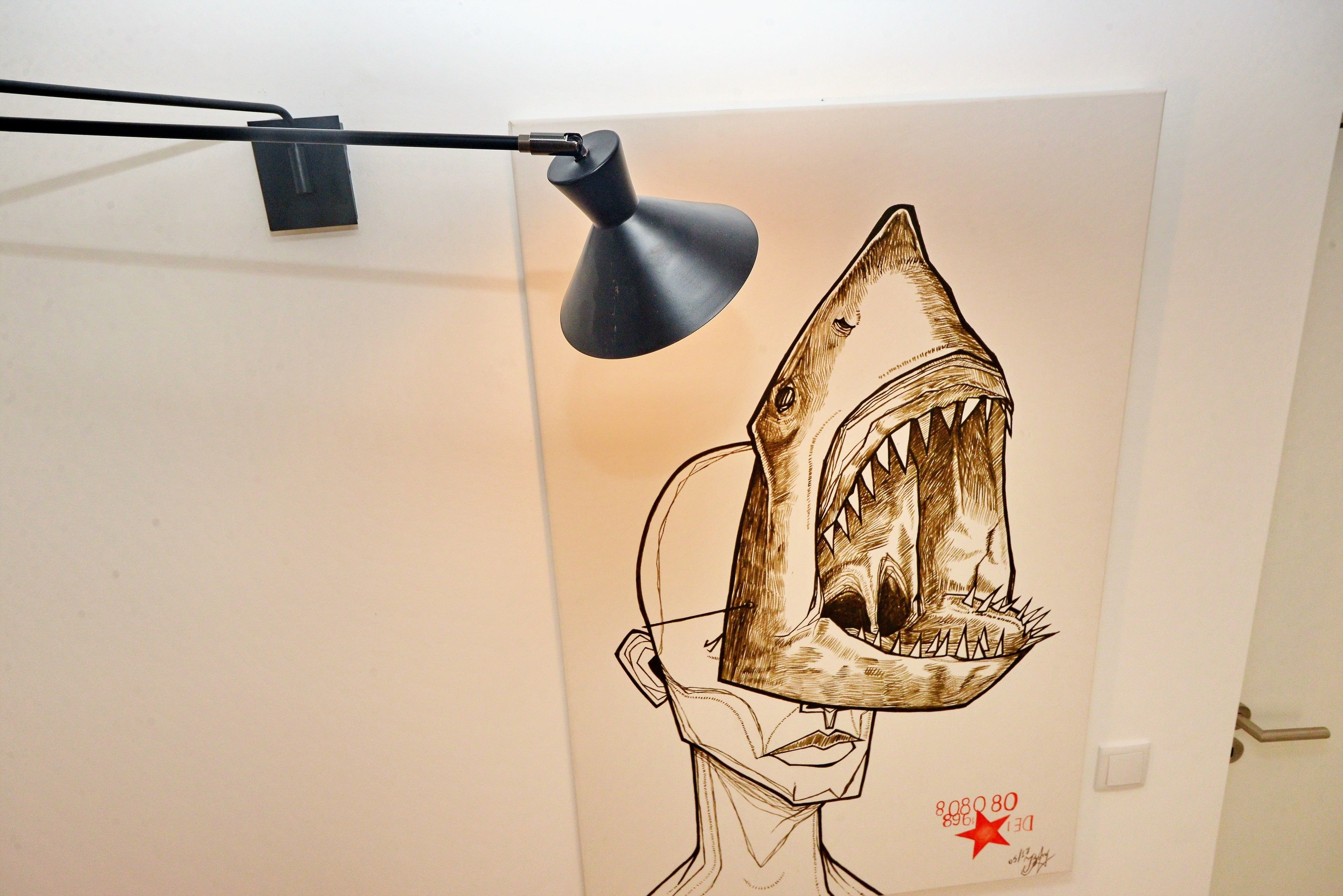 A wall with a large shark illustration and a red star.
