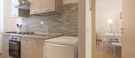 Apartamento conforto, 1 quarto, vista para a cidade | Cozinha privada | Geladeira, fogão, cooktop, máquina de café expresso