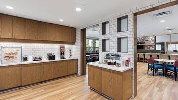 A modern kitchen with wooden cabinets, a white tiled backsplash, and a central island with a sink.