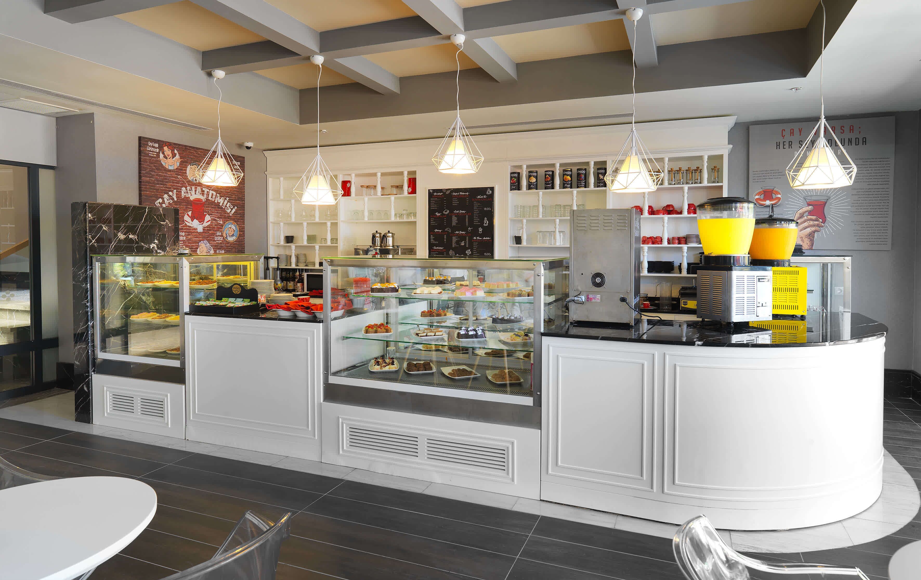 A bakery counter with various pastries and a coffee machine.