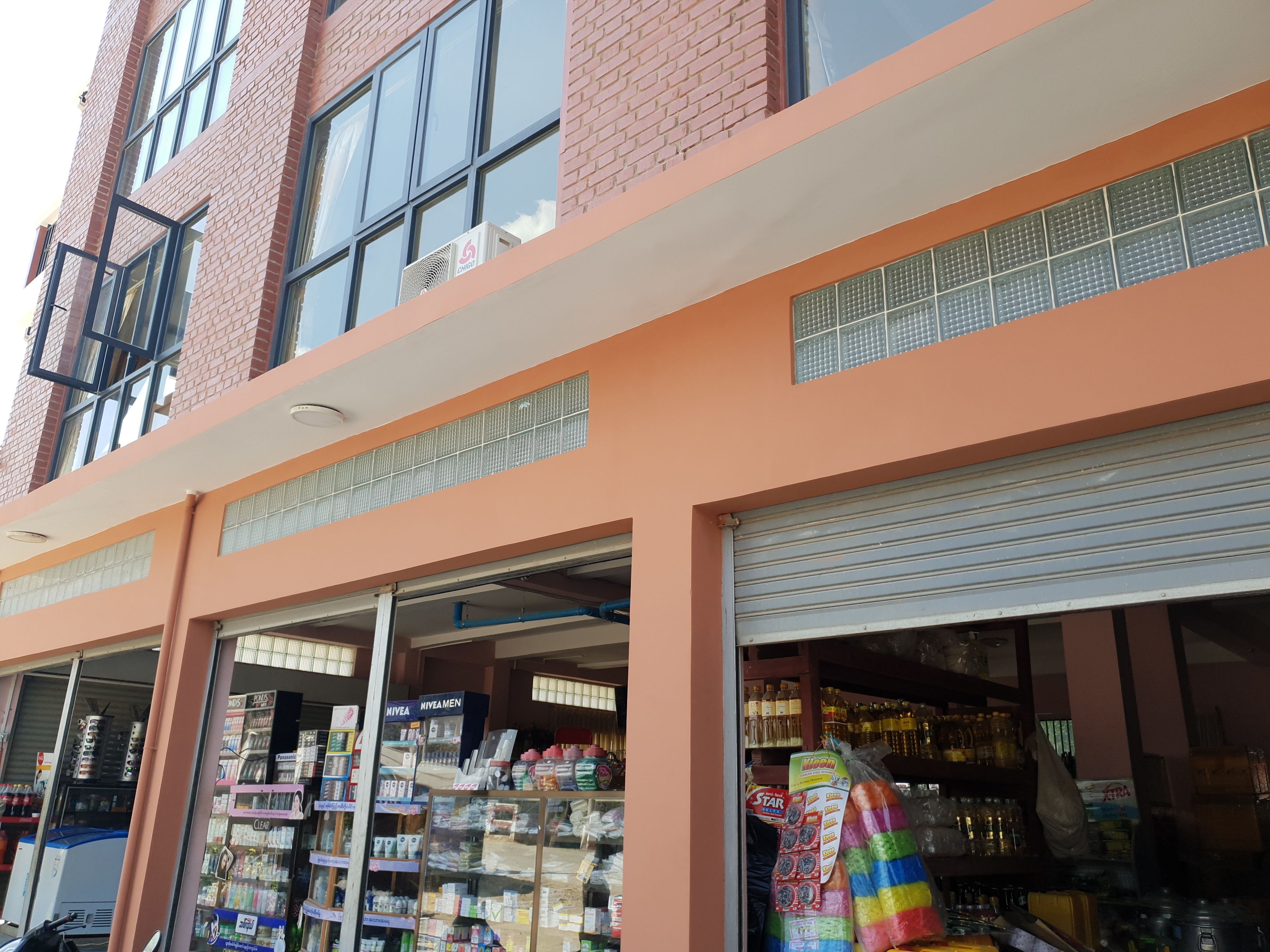 A multi-story building with large windows and a brick facade.
