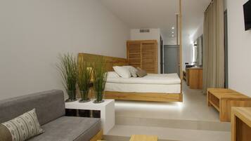 Un dormitorio moderno y minimalista con una cama, un sofá gris y una pequeña mesa de madera.