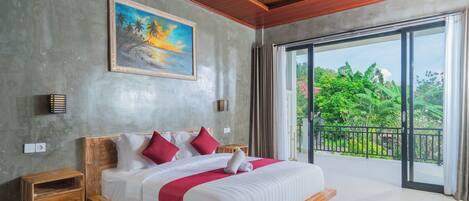 A bedroom with a large bed, wooden headboard, a painting, bedside lamps, and a balcony with a view of greenery.