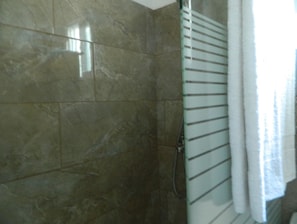 Shower, rainfall showerhead, hair dryer, towels