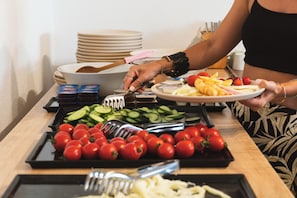 Una mesa de buffet con diversos alimentos y utensilios.