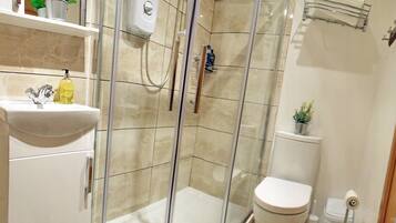 Shower, hair dryer, towels, shampoo