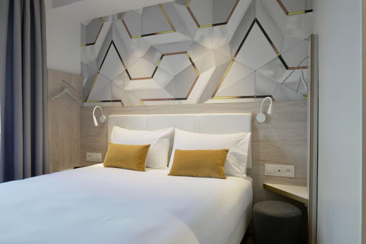 Premium bedding, desk, laptop workspace, blackout drapes