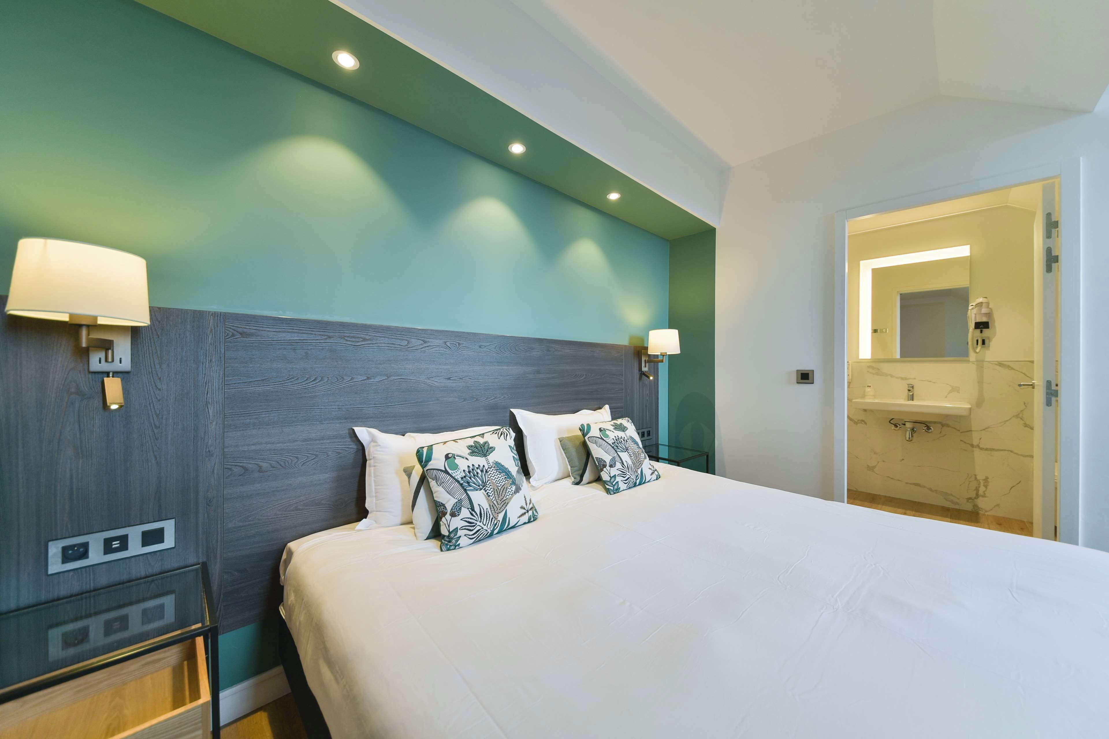 Premium bedding, desk, laptop workspace, blackout drapes