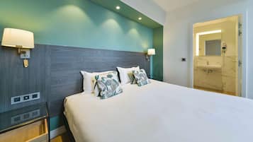 Premium bedding, desk, laptop workspace, blackout drapes