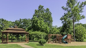 A gazebo and playground with a slide and swings. - Stonebridge Condo and Golf Resort (Branson West)