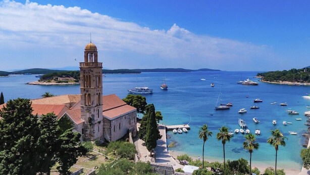 A coastal town with a prominent tower and a marina filled with boats. - Outdoor oasis -apartment, close to center of Hvar (Hvar)