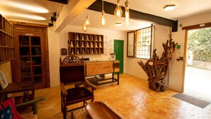 A room with wooden furniture, a green door, and a wooden sculpture. - Quinta Ascension - Adults Only (Malinalco)
