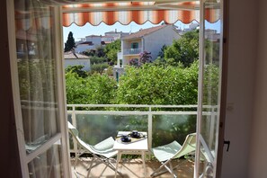 Enjoy a peaceful view of the surrounding neighborhood from this balcony.