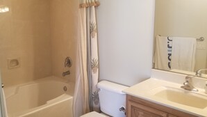 A bathroom with a bathtub, toilet, and sink. - Las Palmas. Great place for a getaway (St. George)