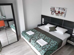 Desk, laptop workspace, iron/ironing board, bed sheets