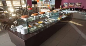 A buffet area with various food items displayed in glass containers.