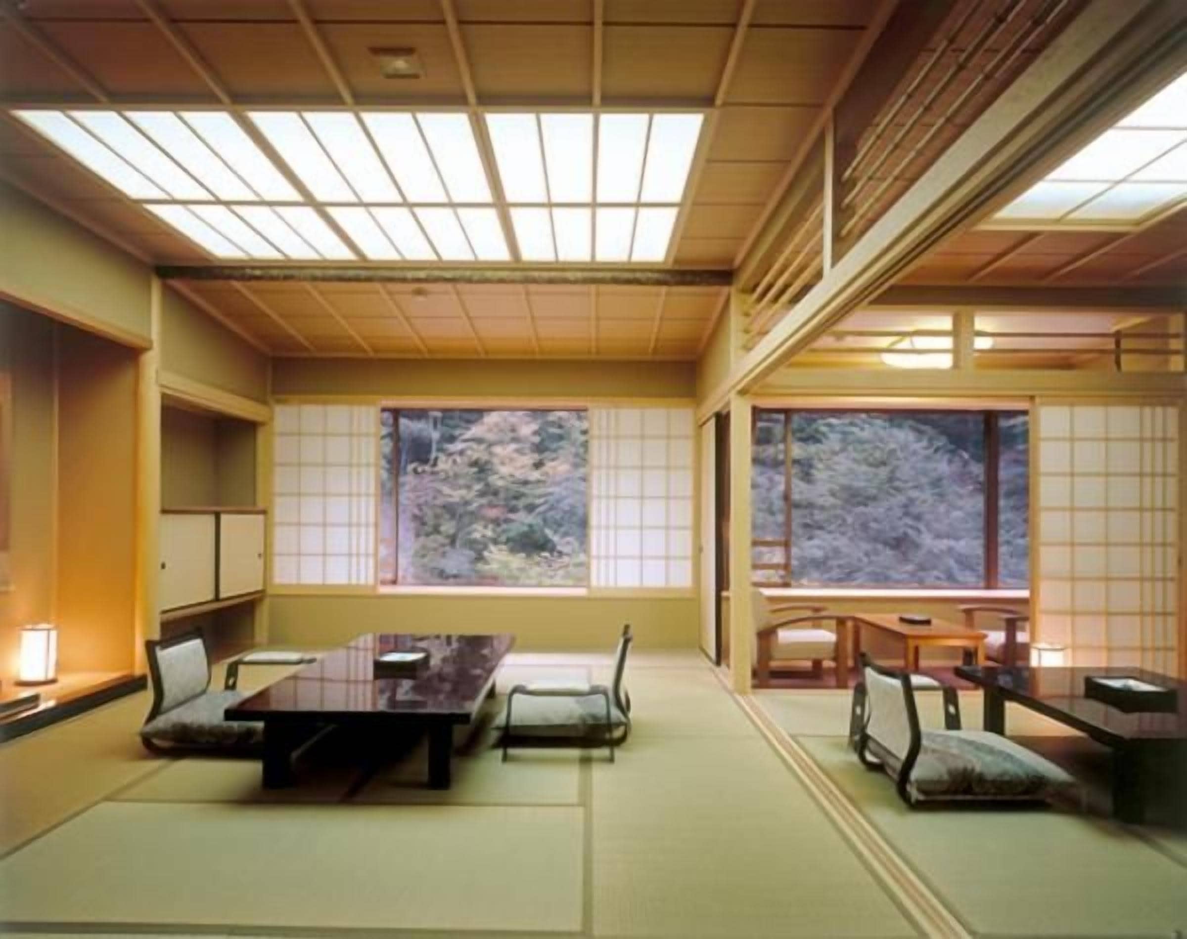 A traditional Japanese room with tatami flooring, a low table, and sliding doors.