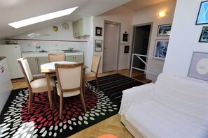A compact living space with a dining area, kitchenette, and a bedroom. - Apartment Ljustina (Silo - island Krk)