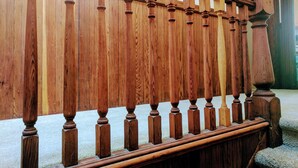 A wooden balustrade with a classic design, leading to a staircase. - Perfect Location - 4BD,1BA - Restored Redwood Home of SF Artists (SF)