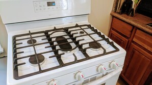 A white Samsung gas stove with four burners and a digital control panel. - Perfect Location - 4BD,1BA - Restored Redwood Home of SF Artists (SF)