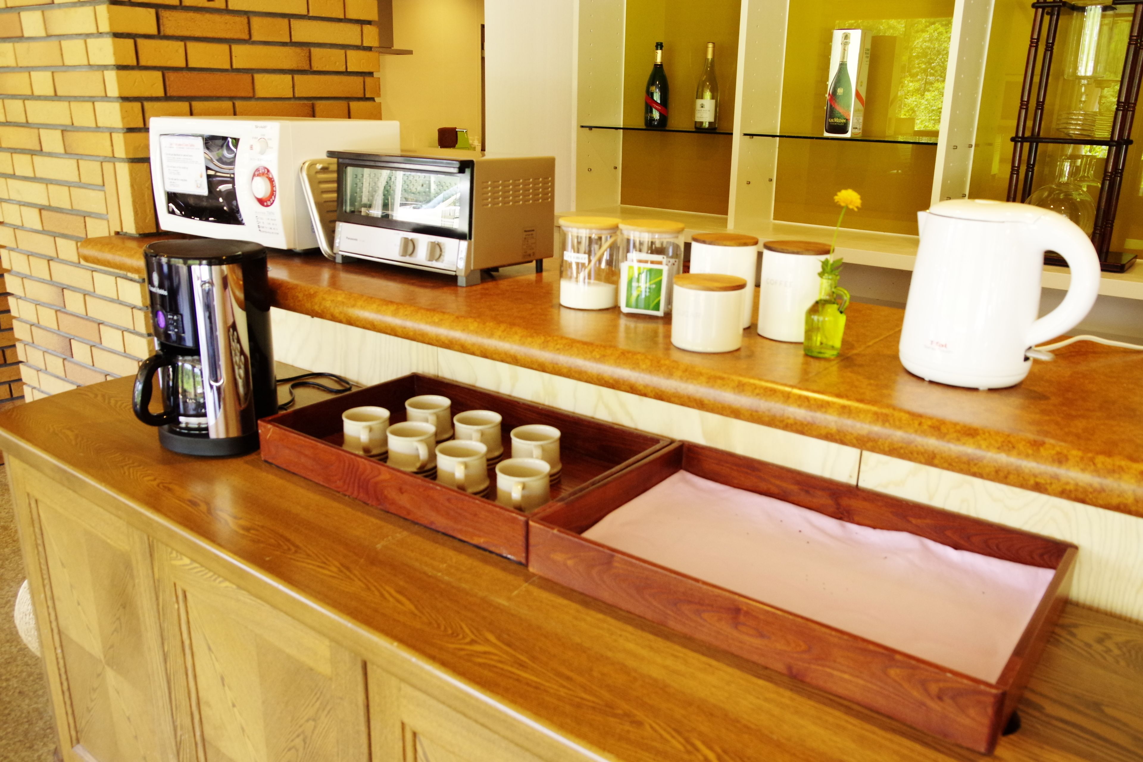 A kitchen counter with a coffee maker, a microwave, a toaster, and various kitchen items.
