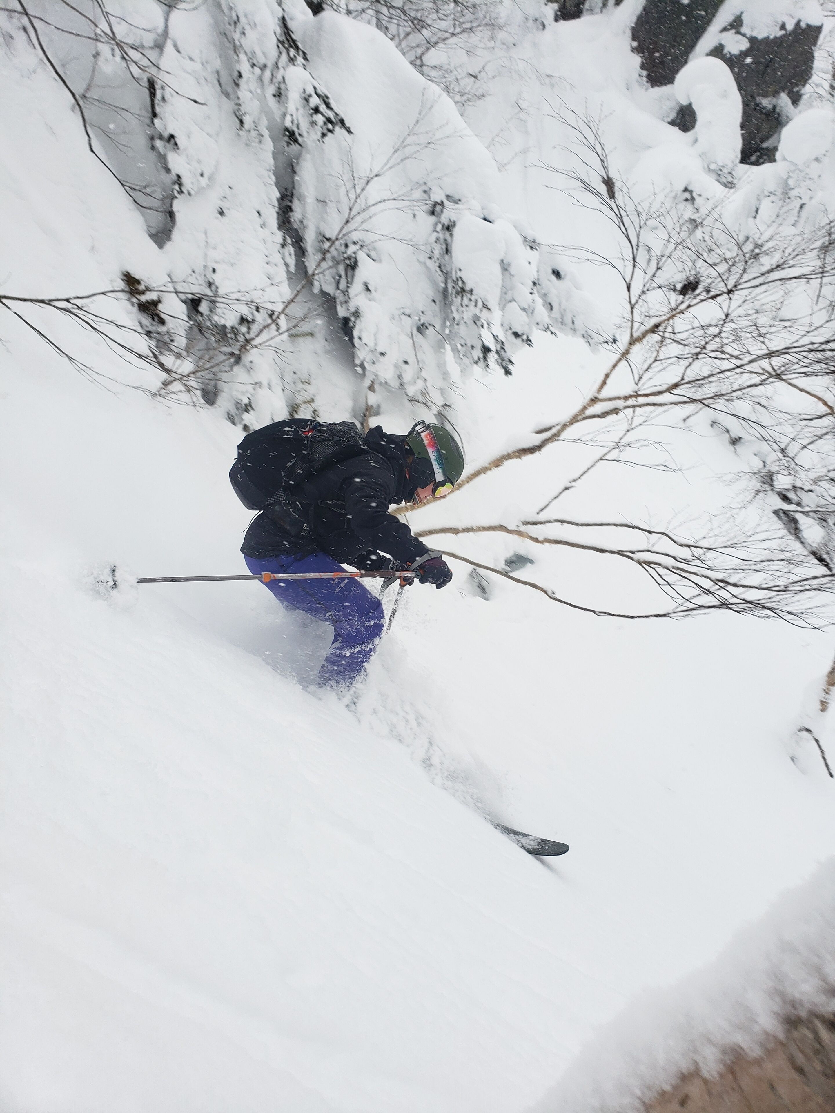 A person skiing down a snowy slope.