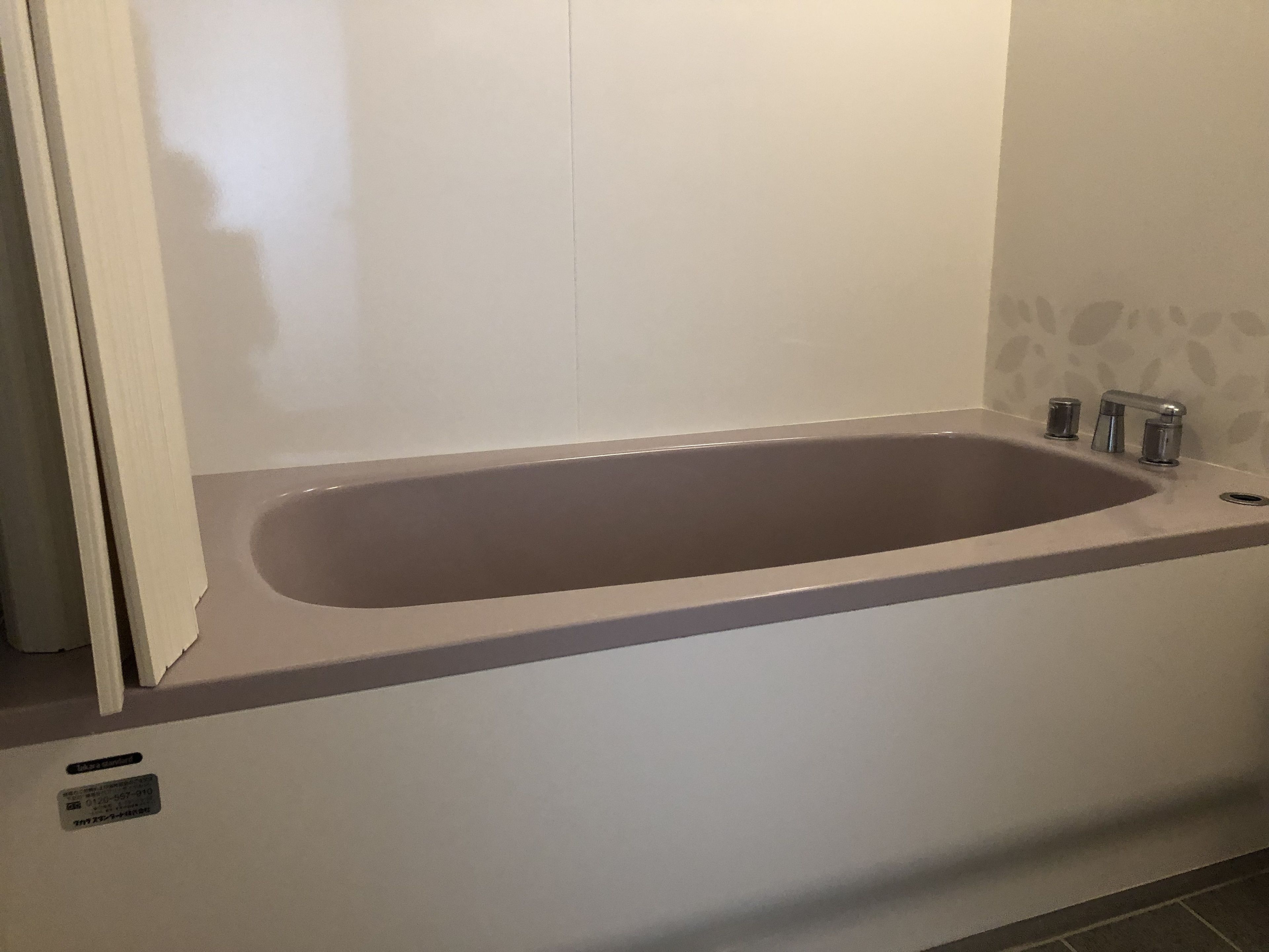 A modern bathroom with a freestanding bathtub, a toilet, and a sink.