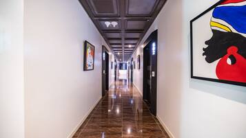 A long, narrow hallway with a polished floor and a ceiling with recessed lighting.