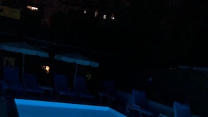 A swimming pool at night with blue lighting. - Meltem Hotel (Konyaalti)