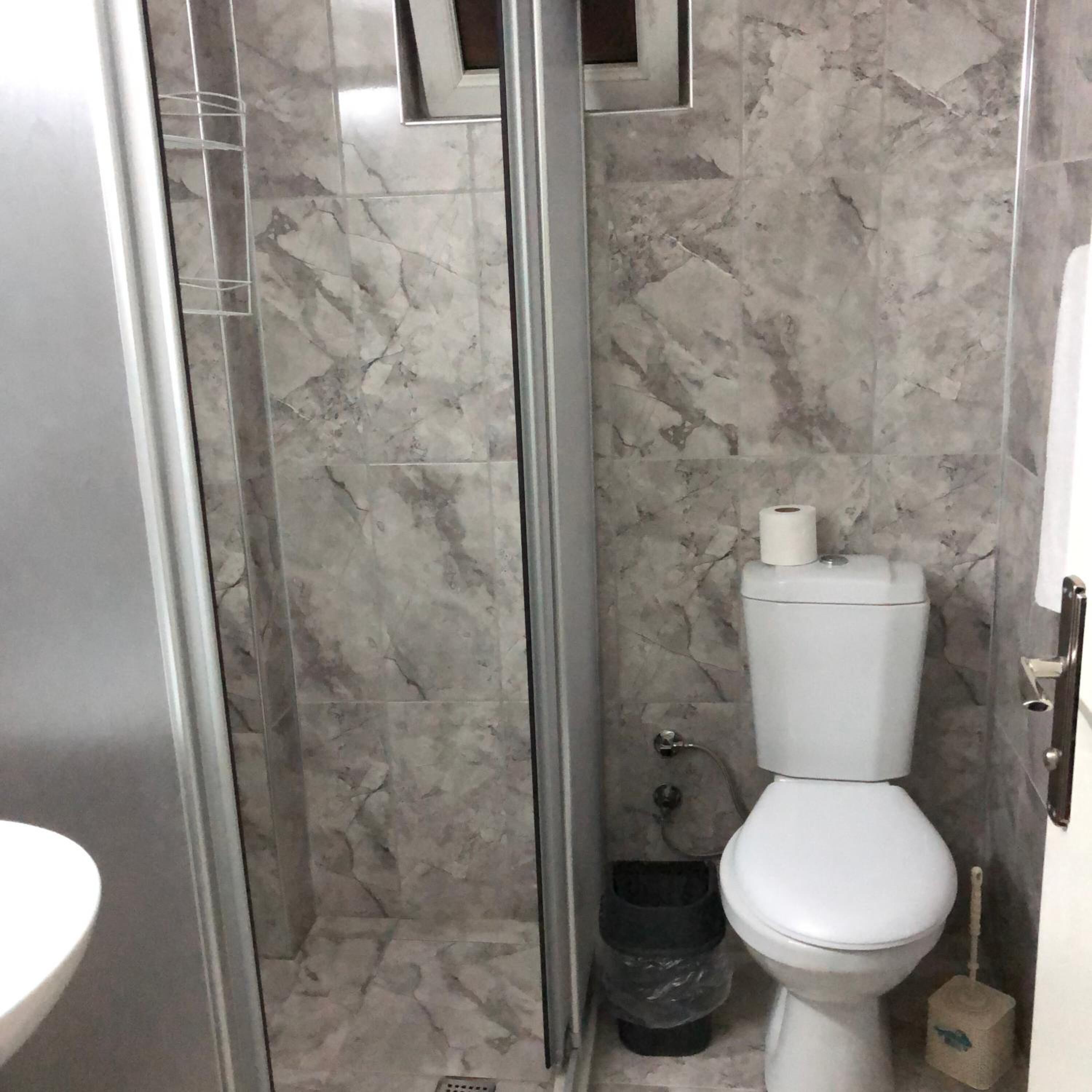 shower, hair dryer, slippers, towels