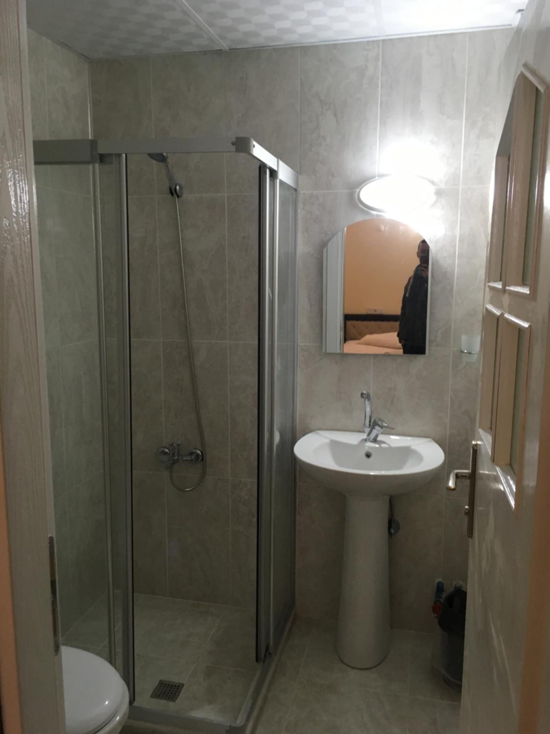 shower, hair dryer, slippers, towels