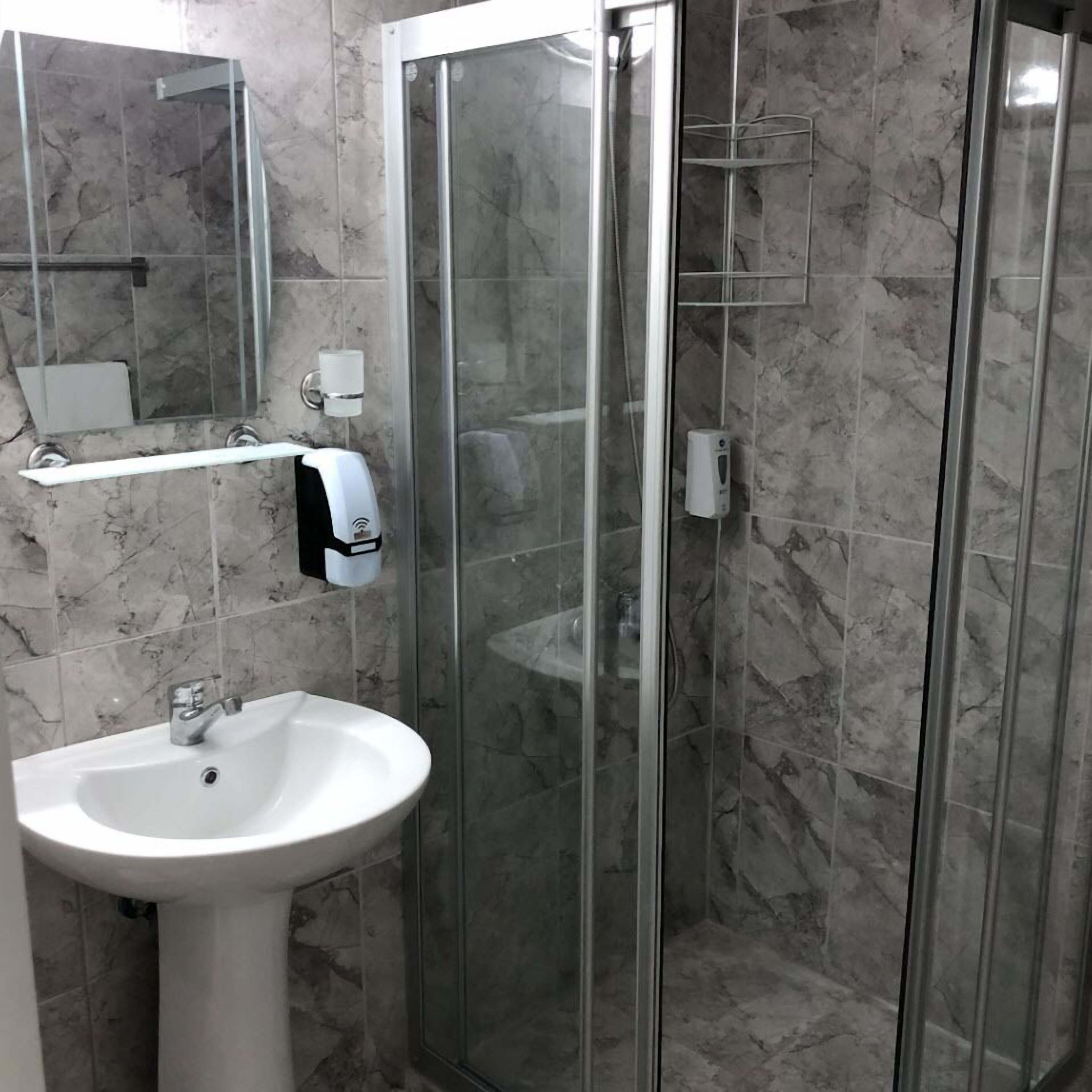 shower, hair dryer, slippers, towels