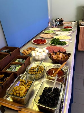 A buffet with various food items including olives, eggs, and meats. - Meltem Hotel (Konyaalti)