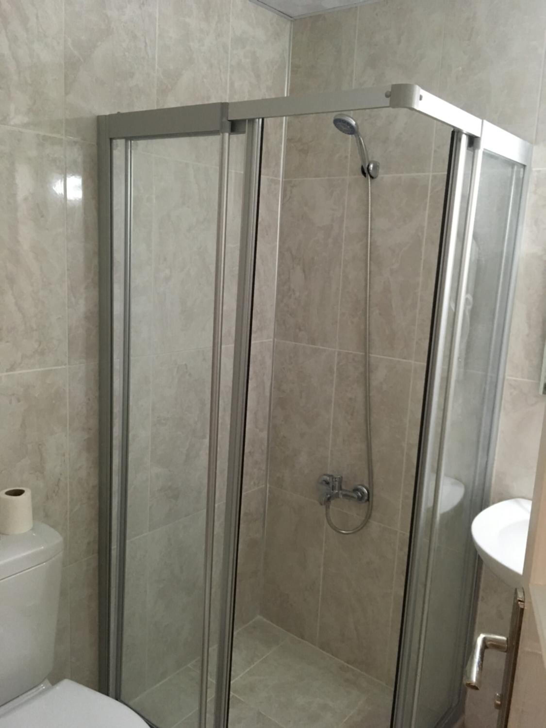 shower, hair dryer, slippers, towels