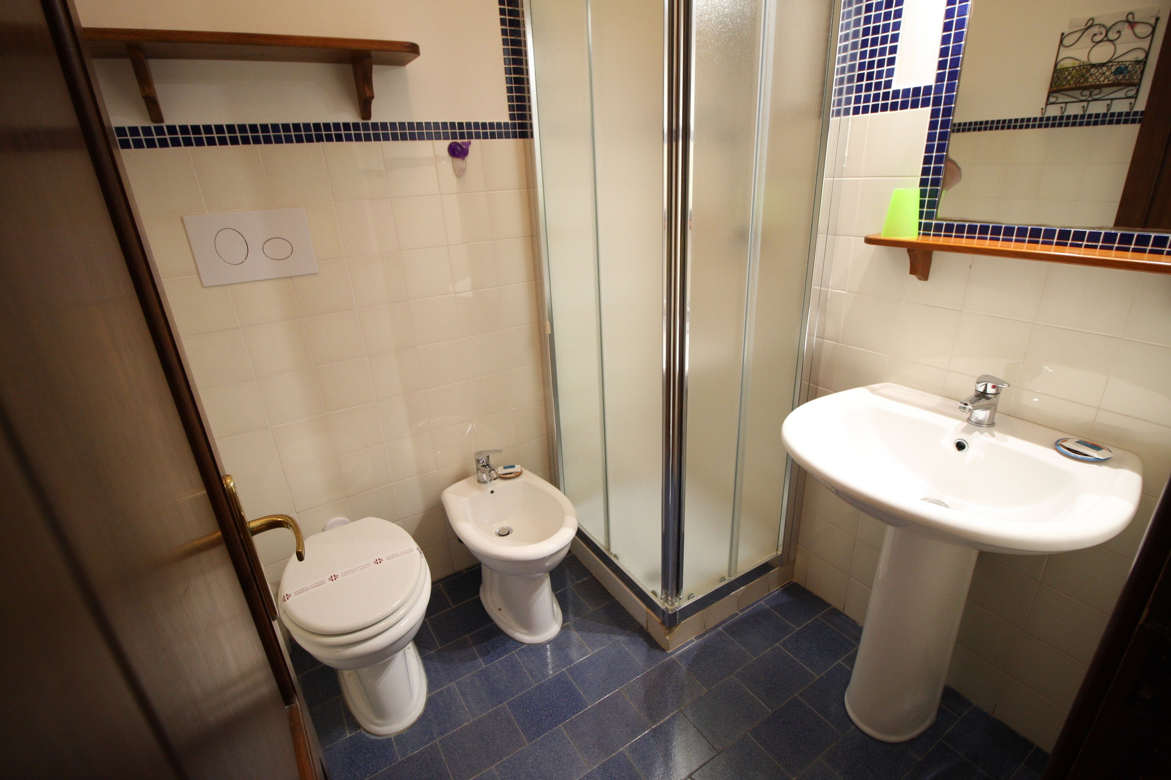Un baño con inodoro, bidé y lavamanos.